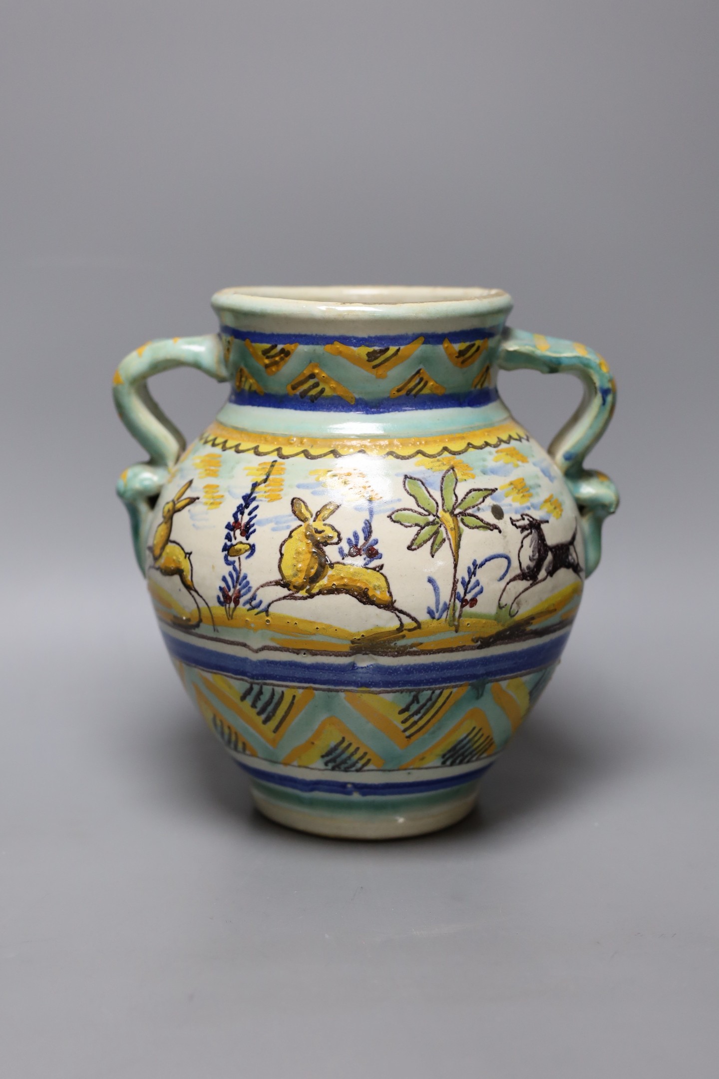 A Italian maiolica vase decorated with hares, 23cm tall